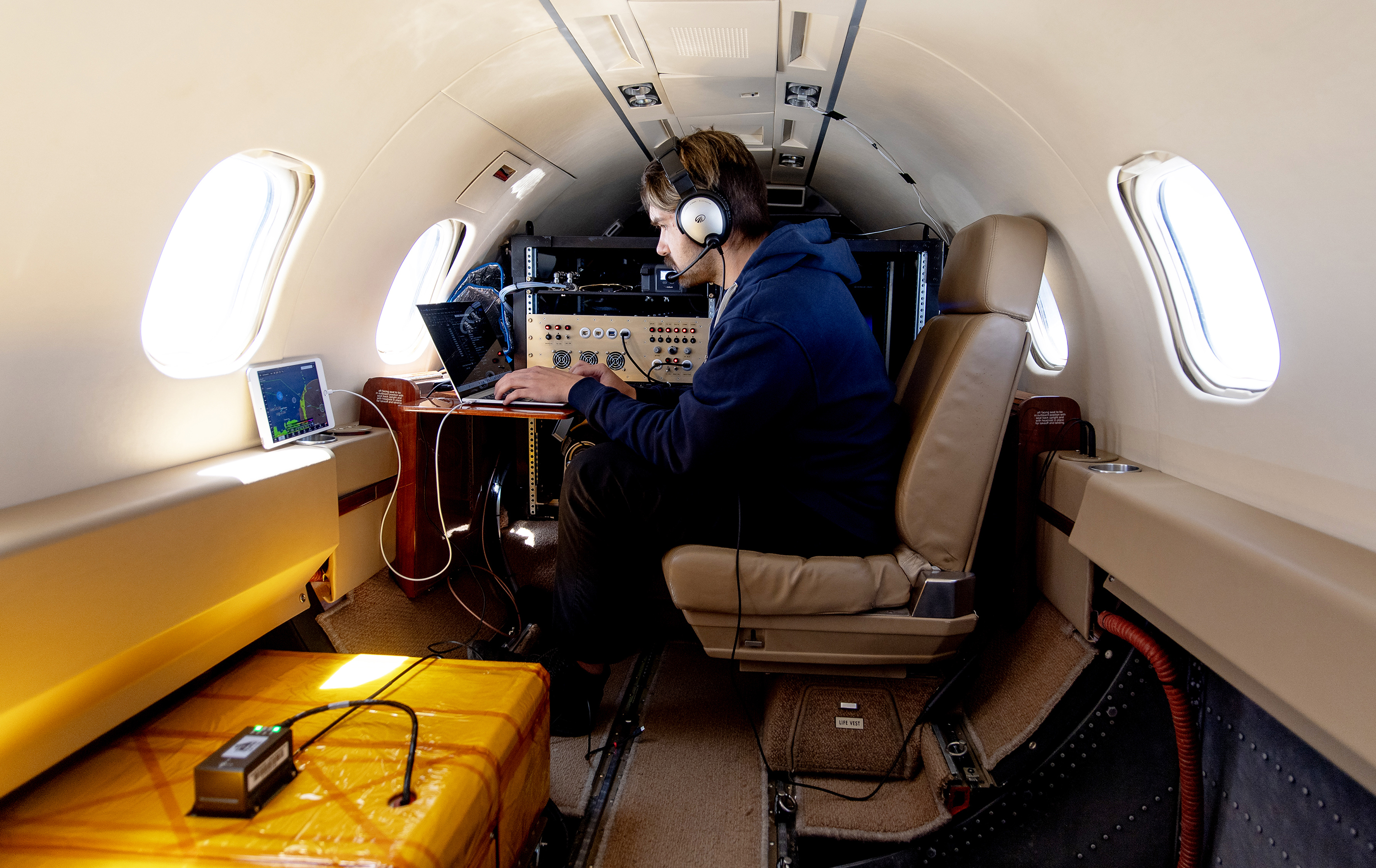 Team member and scientific equipment aboard MethaneAIR.