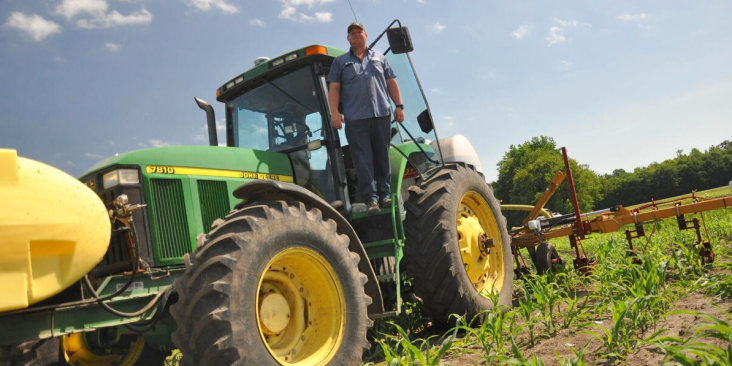 Farmer on tractor at Walton Farms