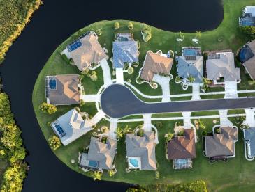 Aerial view of houses in a waterfront community.